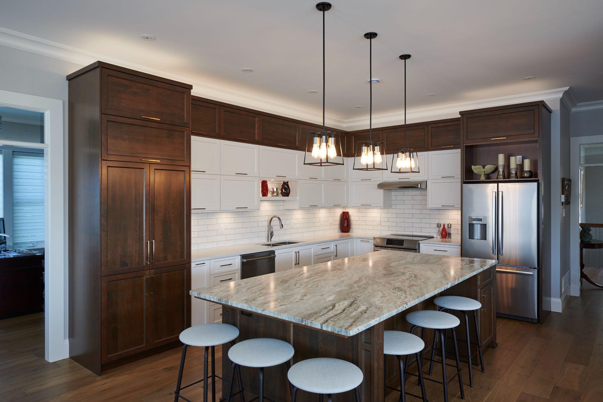 Dark walnut and white kitchen with granite island and industrial pendant lights